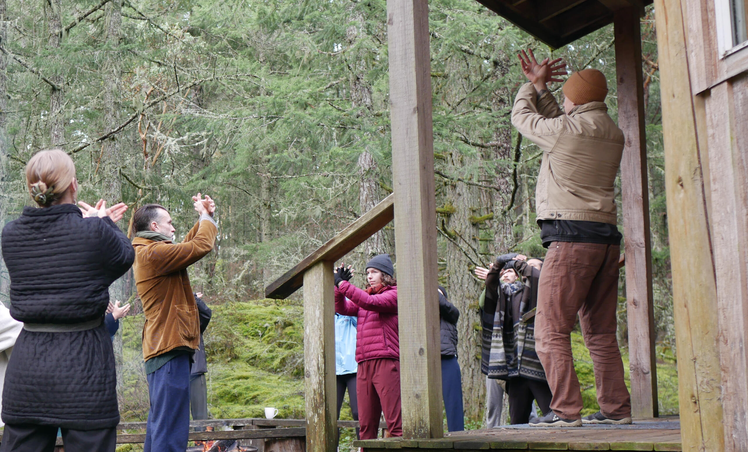 Adrian teaching Qi Gong outside a log cabin to participants on a retreat Adrian teaching Qi Gong outside a log cabin to participants on a retreat